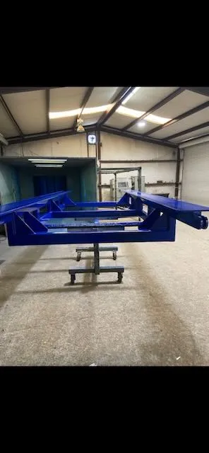 Blue frame assembly in hanging configuration in workshop